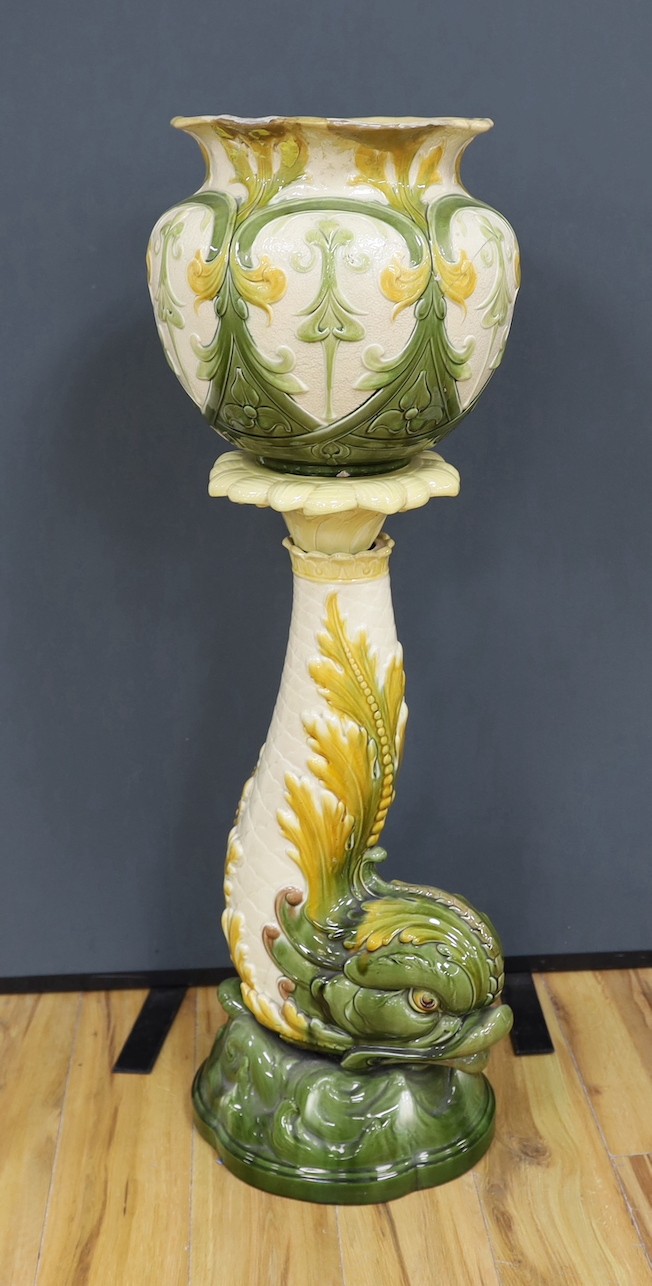 A Leeds Art pottery floral jardinière, on rearing dolphin pedestal - 114cm high